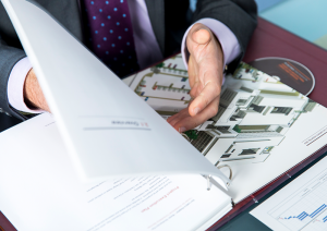 up close of man flicking through a tender