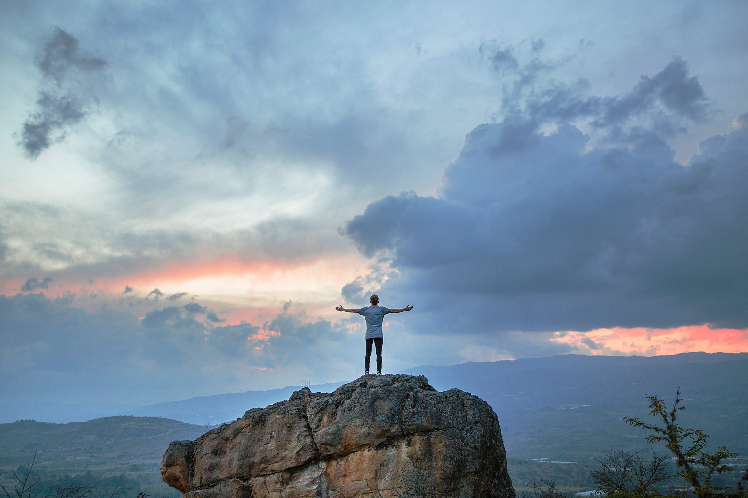 man standing on mountain top