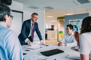 man leading a meeting in a meeting room