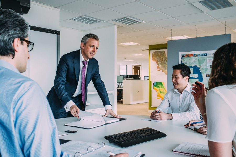 man leading a meeting in a meeting room