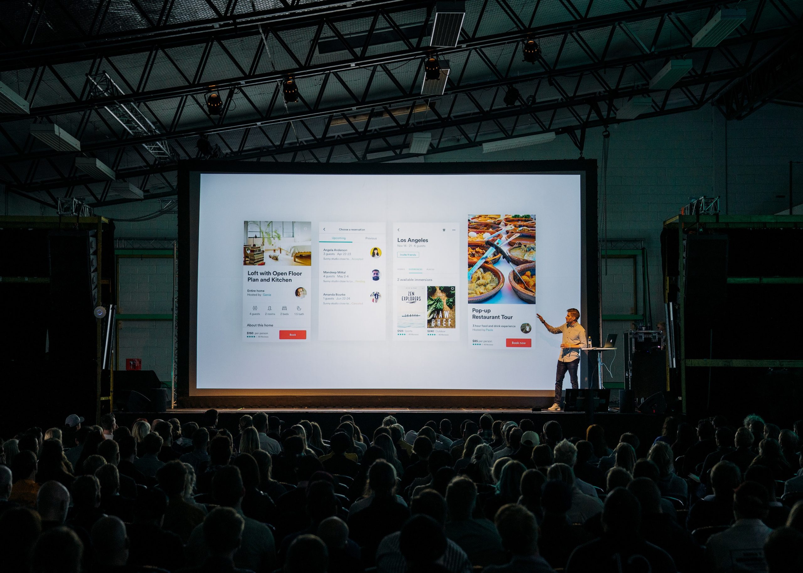 man presenting in front of big audience