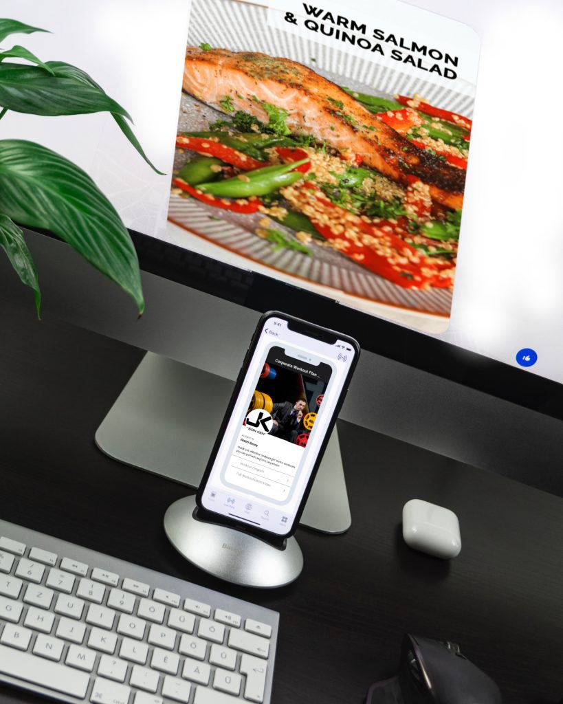phone docked in front of macbook screen