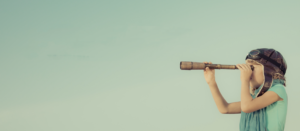 kid looking through telescope