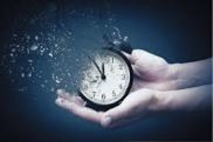 hands holding clock and it breaking away in pieces